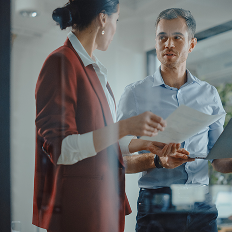 a man and woman looking at papers