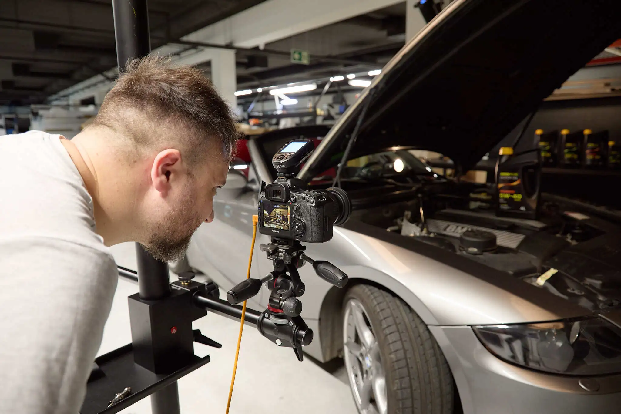 Male photographer shooting a car